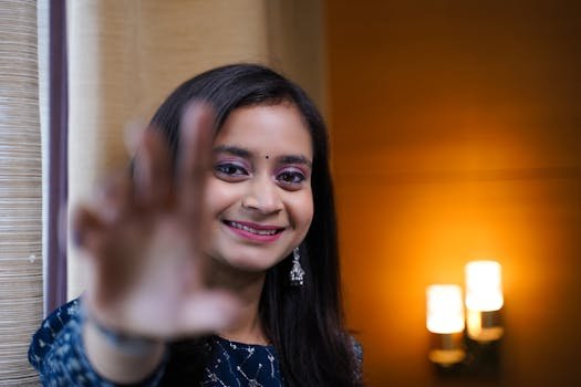 Close-up portrait of a smiling South Asian teenage girl indoors in Varanasi.